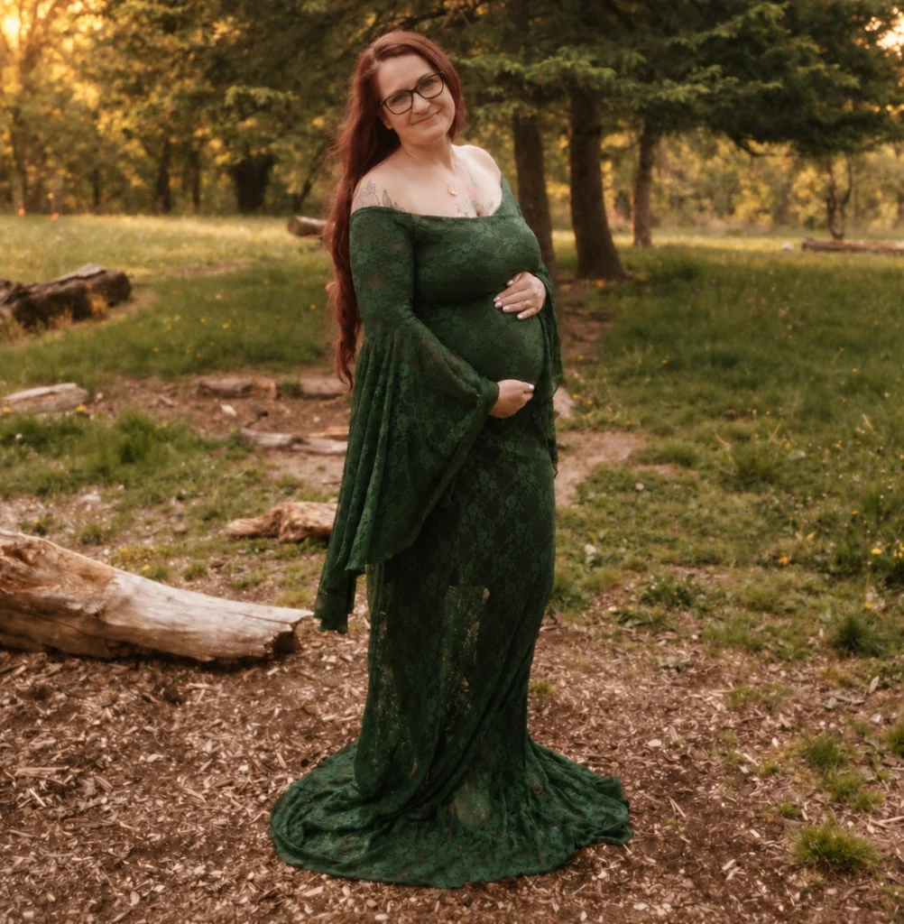 Expectant gestational carrier in a green lace dress outdoors