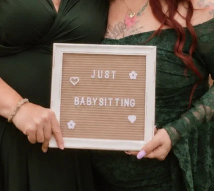 “Just babysitting” letter board held by the founders