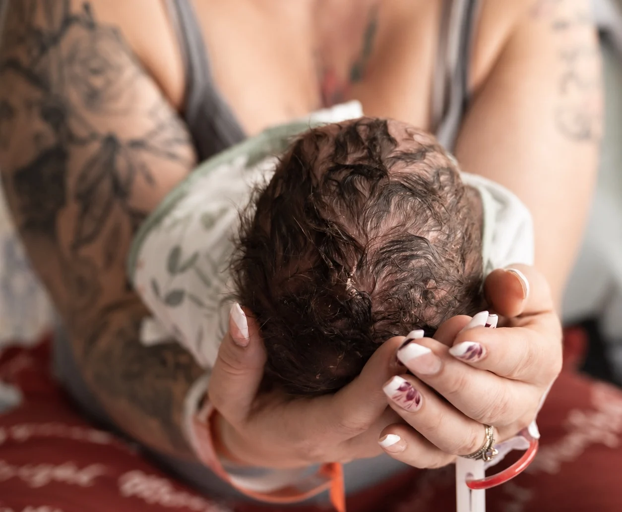 Hands cradling a newborn baby