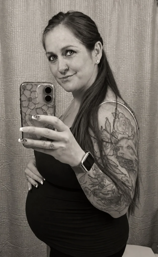 Expectant gestational carrier taking a mirror photo
