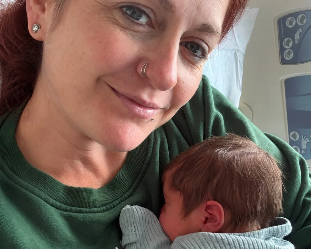 Gestational carrier holding a newborn